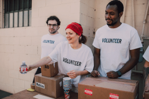 group of volunteers handing out bottles of water