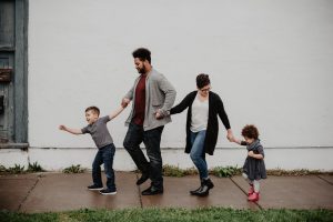 parents and their two children walking and holding hands