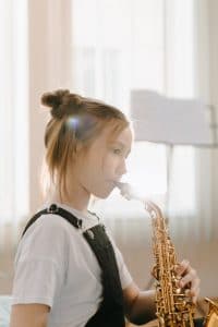 young girl playing the saxaphone